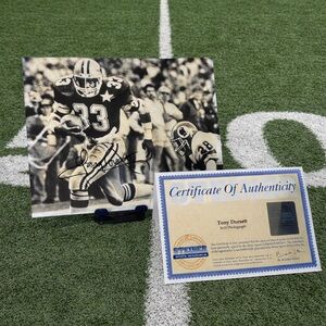Signed Tony Dorsett Football 8x10 Black and White photo.